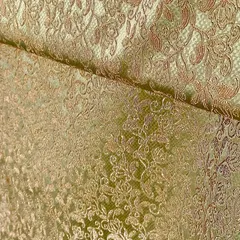 This light green brocade fabric features a dense, gold floral weave. It has a beautiful sheen that makes it perfect for crafting a regal sherwani or a formal bandhgala.
