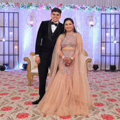 The standing portrait showcases the flattering fish-cut design and the elegant drape of the attached cape. This rental outfit is designed to make you feel confident and stylish at your event.