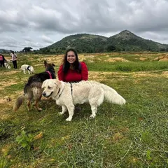 Here I am with a happy Golden Retriever and German Shepherd on one of our nature expeditions. I'm always present to guide the pack, ensuring every dog is safe, comfortable, and having the best time possible.