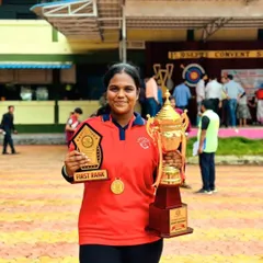 Celebrating a big victory. One of our dedicated students proudly displays her first-rank trophy and gold medal from the Raigad school district archery competition.