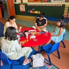 Students gather around the table to assemble their own bhel puri. This activity not only teaches culinary skills but also encourages social interaction and teamwork as they share ingredients and ideas.