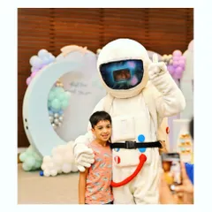 An astronaut mascot poses with a guest at our 'First Trip Around the Sun' party. These character interactions create amazing memories.