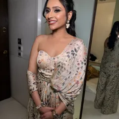 A full view of this chic brunch look. The floral jumpsuit is perfectly complemented by the soft glam makeup and the elegant half-up hairstyle.