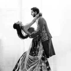 A classic black and white dance pose from a couple's shoot. Her joyful lean back and his supportive hold create a dynamic and timeless image of trust and happiness.