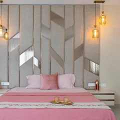 A closer look at the bespoke headboard, featuring upholstered panels and metallic inlays. The design adds texture and sophistication, making the bed the undeniable hero of the room.