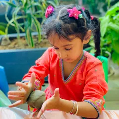 This little artist is concentrating hard as she shapes her clay Ganesha. I love the focus and care she's putting into her creation.
