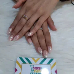 This is the popular 'glazed donut' or pearl chrome look. I applied a special powder over a neutral base to give these almond-shaped nails a beautiful, iridescent sheen.