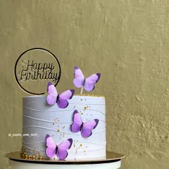 A closer look at the lavender butterfly cake, showing the delicate line work on the buttercream.