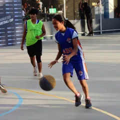 Confidence on the ball is key. Here, one of our players drives to the basket during a tournament, showcasing the dribbling skills and aggressiveness we foster in our program.