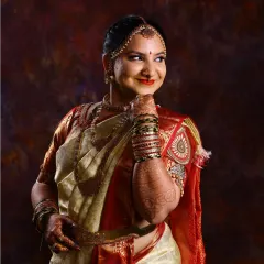 A classic portrait of a bride in her traditional attire. Her mehndi is an essential part of her look, with the dark stain on her hands and arms adding to her bridal glow.