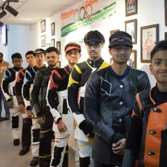Shooters in full competition gear, lining up before the start of the 10m Air Rifle Men's Finals. This part of the process builds discipline and mental readiness for the match ahead.