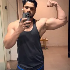 A classic bicep flex in the gym locker room. Lift heavy, get results.