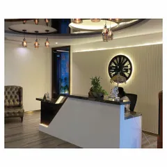 Another view of the SVG Exports reception, showing the interplay of light and materials. The reflective ceiling detail and warm ambient lighting enhance the sophisticated material palette of marble, wood, and polished surfaces.