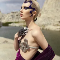 A close-up of the Siren makeup, showing the deep purple glitter eyeshadow and the hand-painted details on the skin.