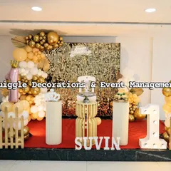 A gold and white themed first birthday party with a shimmer wall and a large light-up number '1'.