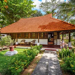 Welcome to Ambara Mana, a 73-year-old Kerala heritage cottage. We restructured this beautiful home in Bangalore to serve as a peaceful guest residence, complete with a garden bath and naturally cool interiors, even in summer.