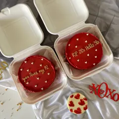 A pair of hot red bento cakes, one cheekily saying "RIP 20s Hello 30s" and the other "You Power my BI" for a techie partner. These are perfect for milestone birthdays or celebrating a relationship.