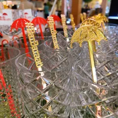 Let's put your wedding hashtag everywhere. Here are custom-designed gold acrylic stirrers featuring the 'BarBaraati' brand, showcasing the kind of detailed personalization I can create for your special day.
