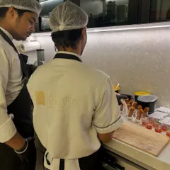 My chefs in action, carefully preparing appetizers for a private house party. We maintain the highest standards of hygiene and precision in the kitchen.