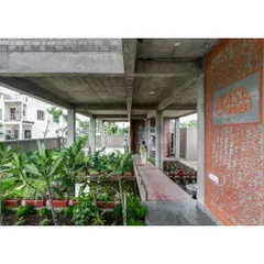 The ground floor of the ASA office, which we transformed into a wetland and public space. A raised brick walkway meanders through the plants and water, creating a cool, welcoming entrance that naturally manages stormwater.