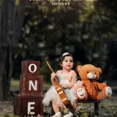 The world is more beautiful with kids in it. A lovely outdoor portrait of a little girl with her teddy bear and ukulele, celebrating her first birthday.