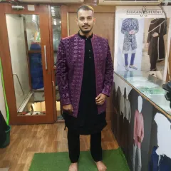 We create outfits in a wide range of colors to suit your style. This client chose a bold purple Jodhpuri jacket with a rich texture, worn over a classic black kurta set for a striking, high-contrast look.