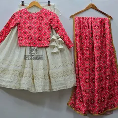 A beautiful twinning lehenga set featuring a white chikankari skirt paired with a pink printed long-sleeve blouse and a matching dupatta. This design is perfect for a coordinated and elegant family look.