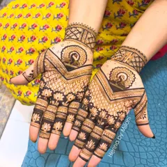 A classic Indian mehendi design featuring a central peacock mandala. The pattern is symmetrical and uses negative space to make the motifs pop.