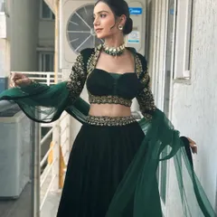 A full-length shot showcasing the dramatic sleeves and flow of the lehenga. The entire look is balanced, with the makeup complementing the outfit perfectly.
