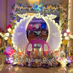 A closer look at the magical butterfly wing entrance, showing the intricate lighting and surrounding floral and pampas grass decor.