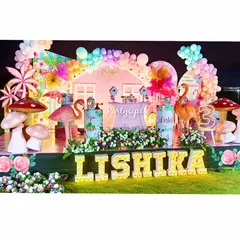 Let's flamingle! Lishika's flamingo-themed party was a vibrant and tropical celebration. The full stage setup featured large flamingo and mushroom props, marquee letters, and a colorful balloon arch.