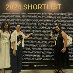 Our team at the World Architecture Festival in Singapore, proudly pointing out our firm's name on the 2024 Shortlist wall. It's a surreal moment to see our work recognized among the world's best.