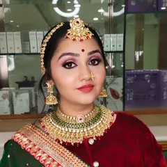A close-up portrait of a happy bride, looking radiant and confident. Her makeup features a beautiful pink smokey eye.