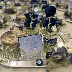 A different angle of the Evil Eye themed hamper, showing the arrangement of the personalized card, silver bowls with navy pouches, and a small floral accent. The theme is both modern and deeply traditional.