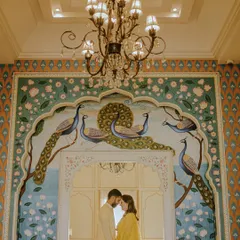 Set against the stunning backdrop of a Jaipur palace, this shot captures a regal and tender moment. The intricate peacock mural and grand architecture add a layer of timeless romance, perfect for couples dreaming of a heritage pre-wedding shoot.