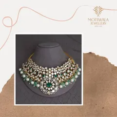 This grand bridal necklace is a masterpiece from my heritage collection, featuring uncut Polki diamonds and vibrant emeralds. It is designed for the bride who wishes to carry a piece of royal history on her most important day.