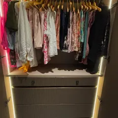 This is the 'after' view of a client's wardrobe, complete with integrated lighting. Every item is now visible and accessible, making the morning routine so much smoother.
