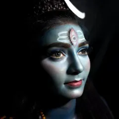 This portrait captures the serene yet powerful expression of the Shiva-inspired look. The detailed work on the Tripundra and the third eye is central to this divine transformation.