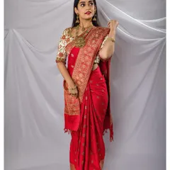 A full-length view of the bride's gorgeous red saree and antique jewelry, a timeless and classic bridal look.