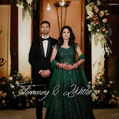 A beautiful reception portrait of the couple. The bride's emerald green gown stands out, and the photo captures the elegance and happiness of their celebration.