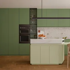 A closer look at the olive kitchen, showing the integrated tall unit for appliances and a functional island with a marble top. The design is all about maximizing storage while maintaining a sleek, uncluttered aesthetic.