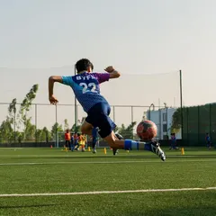 Flying high! This shot captures the power and technique we instill in our players. It's about giving everything in every moment, reaching for that spectacular goal.