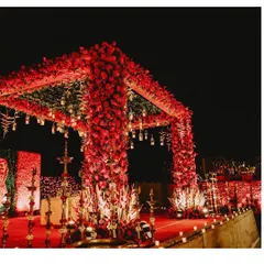 A classic red wedding mandap is timeless. I designed this one to be completely covered in red roses, with hanging lights and traditional elements for a look of pure romance and grandeur.