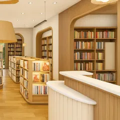 The curved, fluted reception desk serves as a central point in the library. The design combines white solid surfaces with warm wood tones, reflecting the clean and natural material palette used throughout the space.
