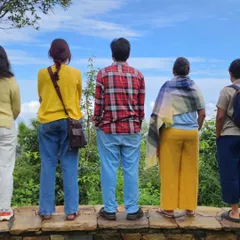 A group of participants taking a moment to admire the valley view together. Shared silence is as much a part of the community experience as shared stories.