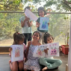 Magical smiles all around! This happy group from our summer camp is showing off the beautiful flower vase art they created using a wax-resist technique.