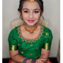 A beautiful portrait of Poorvi, looking like a little doll in her traditional pavadai davani (half saree) and jewelry. The makeup is kept light, fresh, and perfectly age-appropriate.