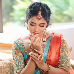 For this traditional photoshoot, I focused on creating a flawless base and highlighting the eyes. The intricate jewellery and bright saree are the stars, and the makeup is designed to complement them perfectly.