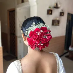 Another angle of this stunning floral bun, perfect inspiration for brides who love fresh flowers.
