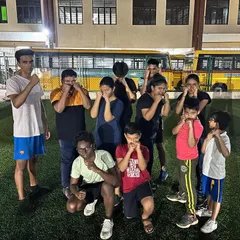 The summer camp crew having some fun while practicing their guard. Our program for kids balances serious training with enjoyable activities to keep them motivated.